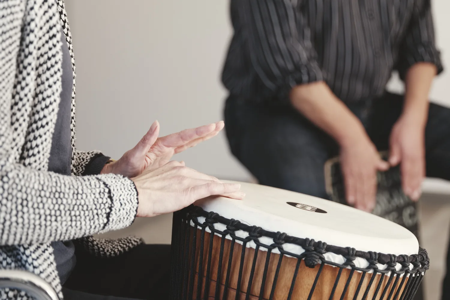 Nahaufnahme von Händen, die eine Djembe-Trommel spielen